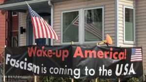 Sign in front of my house and the American flag