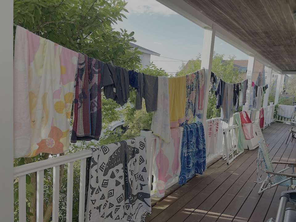 Towels ‣ I Have An Idea Clothesline across a sunny balcony with colorful towels and garments drying